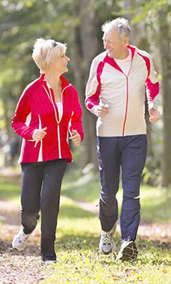 Elderly Couple Jogging in the woods